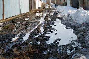 A dirty spring road in a garden village