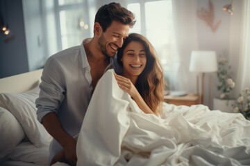 Happy couple in bed, playful, intimate moment, love, relationship, joy, cozy, morning, romance