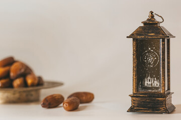 Arabian lantern and bronze plate with dates. Islamic holidays concept. Ramadan decoration. Islamic Holy Month Greeting Card