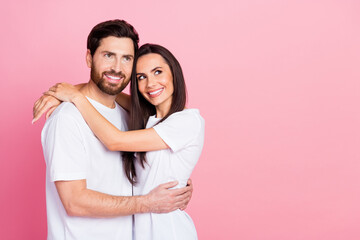 Fototapeta premium Photo portrait of attractive young couple hugging look empty space wear trendy white clothes isolated on pink color background