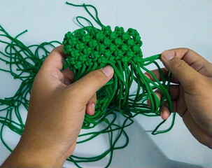 Unfinished craft from green rope