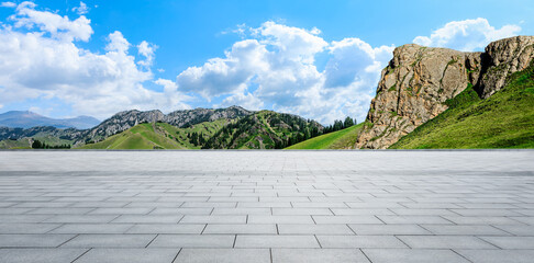 Empty square floor and green mountain nature landscape under blue sky. Panoramic view.