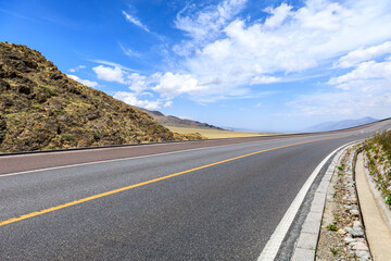 Asphalt highway road and mountain natural landscape under the blue sky