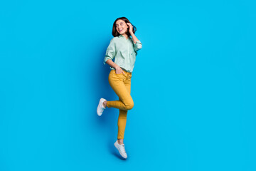 Full length photo of gorgeous woman dressed teal shirt yellow trousers jumping look at sale empty...