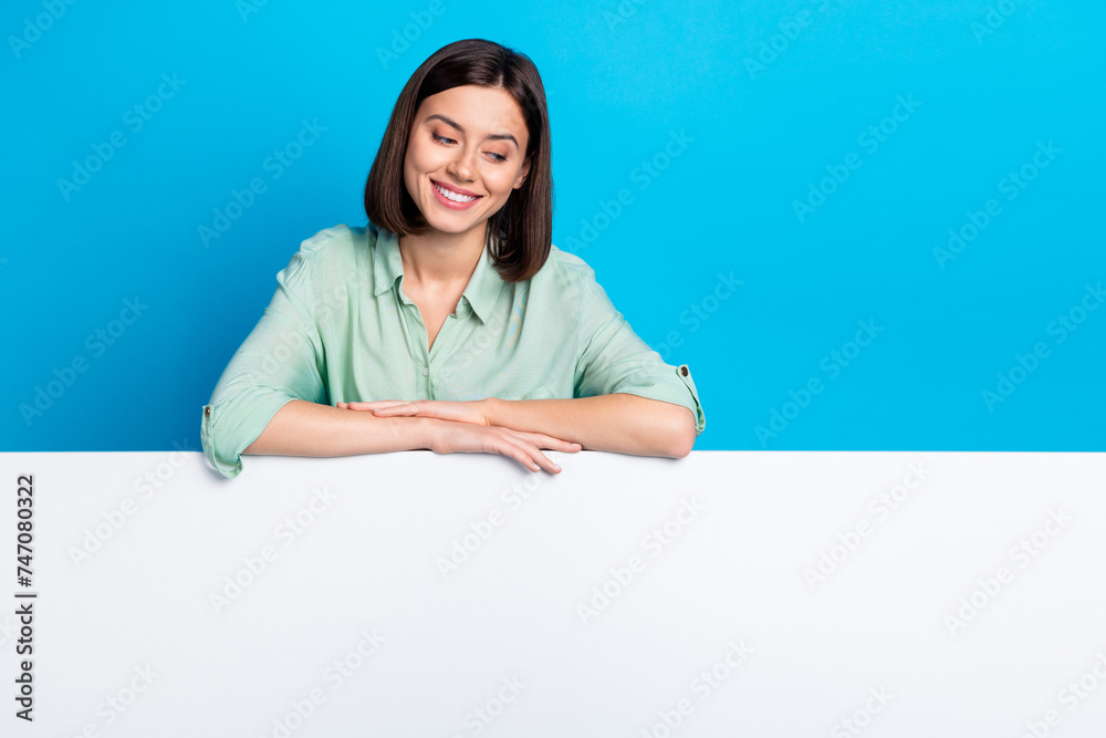 Sticker photo of cheerful woman with bob hairstyle dressed teal shirt look at sale on billboard empty space 