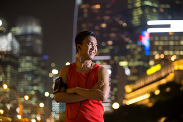 Sporty Asian man outdoors in urban city at night