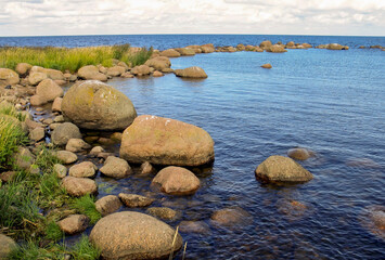 large stones and boulders on the shore of the Gulf of Finland on a summer day