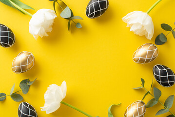Easter opulence reimagined. Top view snapshot of lavish black and gold eggs, pristine eucalyptus branches, airy tulip blooms, on a striking yellow surface with space for copy or ads