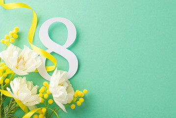 Women's Day creative theme. Overhead shot of the number 8, bouquet of tulips and mimosa, and yellow...