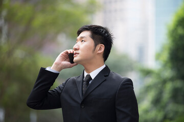 Chinese business man using a smartphone.