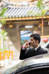 Chinese business man using a smartphone.