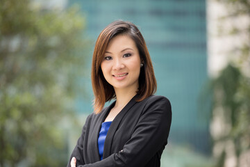 Asian businesswoman standing outside.