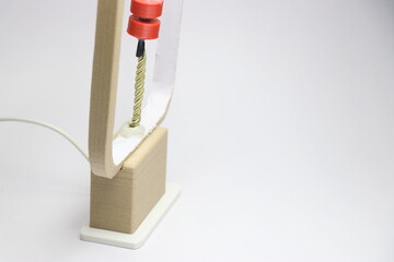 New type of desk lamp that is controlled by a phone and looks futuristic side view. 3d printed objects made at home