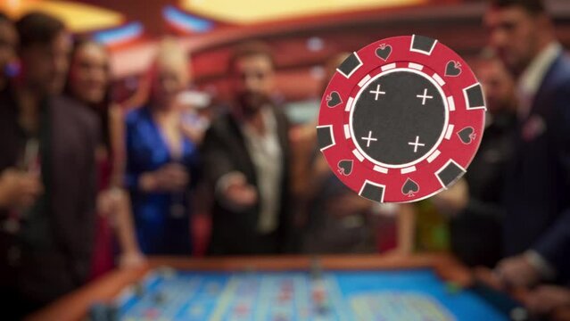 Multiethnic Young Adults Playing an Engaging Game of Roulette, Spending a Fun Evening in a Fancy Hotel Casino. Enthusiastic Gambler Tossing a Red Casino Chip with a Template Placeholder