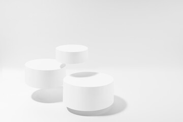 Three white round podiums levitate, mockup on white background with shadow. Template for presentation cosmetic products, gifts, goods, advertising, design, display, showing in soft summer style.