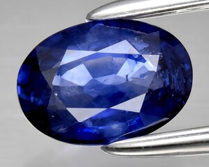 natural blue sapphire gem on the background