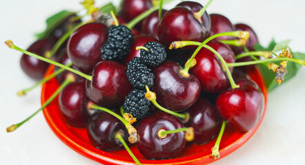 There are red cherries on a white background