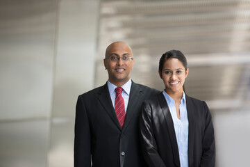 Fototapeta premium Indian business man and woman in a modern urban setting.