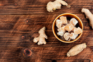 Candied ginger on wooden table.