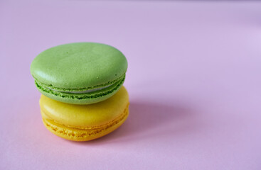 Multicolored macaroons on a pink background. A close-up of cookies.