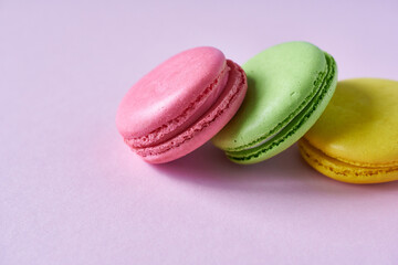 Colorful macaroons on a pink background. Close up.