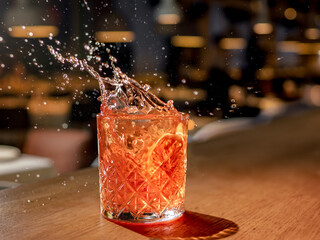 Red brown cocktail with splashes in nightclub