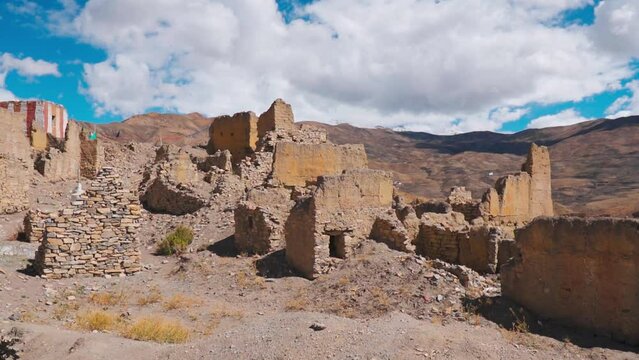 Old Hikkim Monastery's ruins on the cliff near Hikkim village at Spiti Valley, India. Ruins of old build structure with clouds in sky. Spiti valley tourism and holidays during summer season.