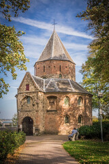 Fototapeta na wymiar medieval building, Sint Nicolaaskapel, in Nijmegen, the Netherlands surrounded by trees in a park.