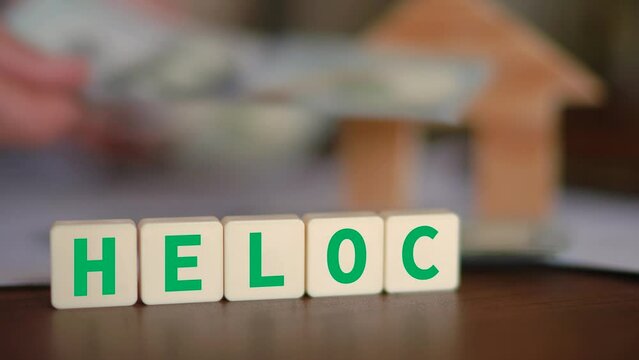Concept of HELOC loan. Receiving cash after a Home Equity Line Of Credit approval. Selective focus and a person counting cash on the background.