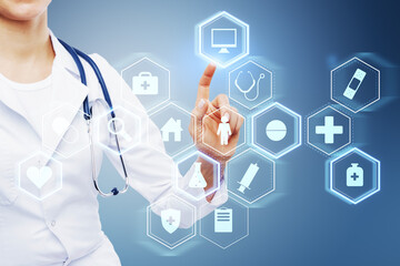 Close up of female doctor hand pointing at creative glowing blue medical interface hologram on blurry background. Digital healthcare, future and research concept.