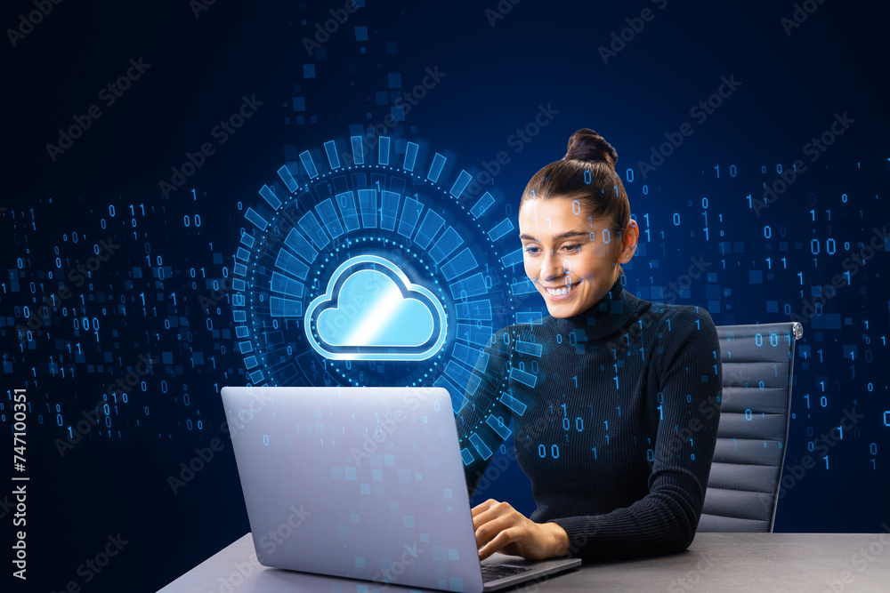 Aufkleber Attractive young european woman using laptop at desk with creative glowing cloud computing hologram with binary coding on dark blue background. Digital server, support and network concept.