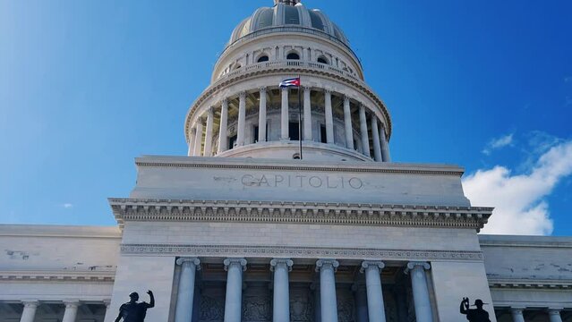 The famous building of the National Capitol in Cuba. HAVANA - DECEMBER 20, 2023: The entrance staircase and the dome of the Capitol in the center of Havana against the background of a blue sunny sky.