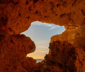 Sunset at the end of a tunnel Algar seco cliffs and caves, Carvoeiro, Lagoa, Algarve, Portugal.