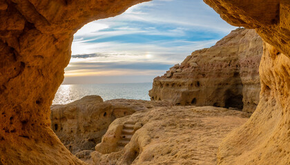 Natural caves with a stunning view of a sunset over the Atlantic ocean, Algar seco cliffs,...