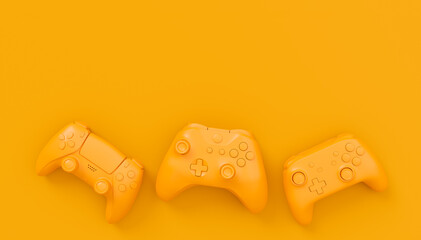 Video game joysticks or gamepads in plain monochrome yellow color background © Vasyl Onyskiv