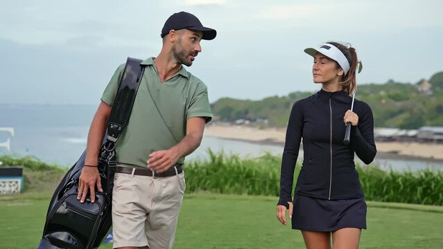 Sports Man and Athletic Woman Walk at Golf Course with Clubs and Balls in Bag. Happy Couple of Caucasian People Ready to Play Game with Putter. Modern Concept of Professional Male and Training Female