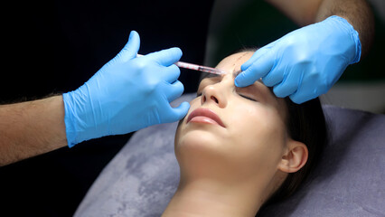 Close-up of a woman's face undergoing cosmetic injections. Wrinkles as a manifestation of skin...