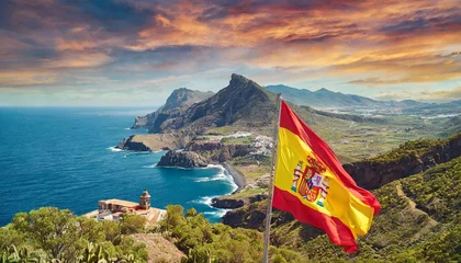 Fototapeten Spanish flag in the iconic beautiful rural landscape of the coast © Denis