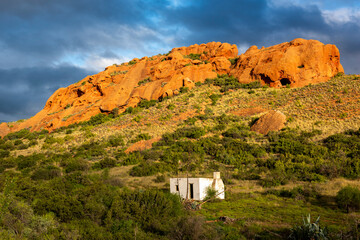 Red Stone Hills, Calitzdorp Farm in the Karoo with old rural houses, valleys pastures aloes and...
