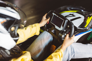 hands behind the wheel of go kart, competition, recreational, race