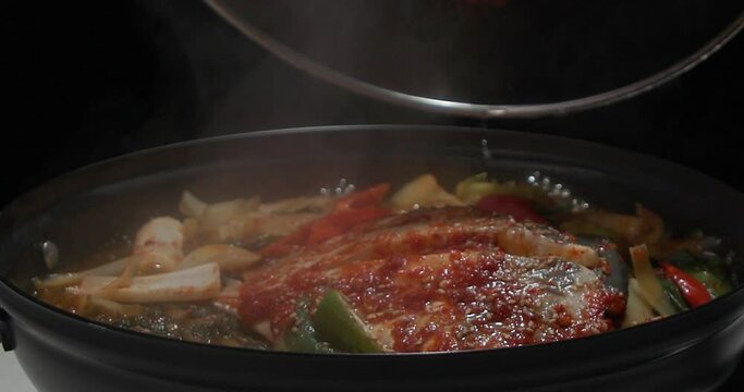 전골 냄비에서 빨갛게 양념한 생선찜이 끓고있는 