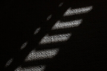 light flickering onto the carpet in a dark room