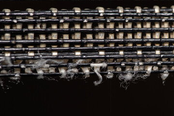 Close-up macro shot of fibers woven together from a chair, forming symmetrical pattern