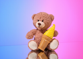 Soft bear and fake ice cream in a waffle cup. The idea of childhood and cheerfulness.