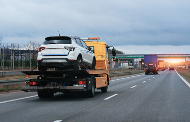 Fototapeta na wymiar Towing Truck With A Damaged Vehicle After Car Accident Collision