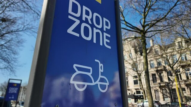 Sharing bike drop zone sign in city, sharing economy, scooter