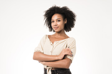 Confident woman with arms crossed on a white background.