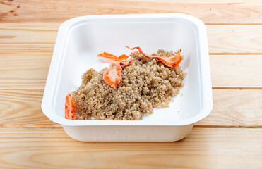 Steamed bulgur. Healthy food. Takeaway food.  On a wooden background.