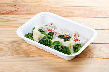 Chicken roll with vegetables. Healthy food. Takeaway food. On a wooden background.