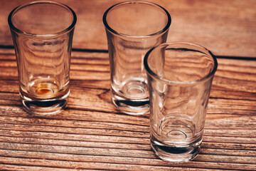 empty vodka glasses on wooden background